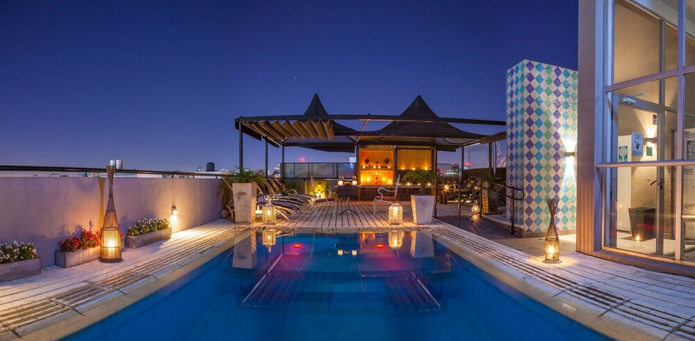 Rooftop pool area with a glass enclosure at Be Hollywood