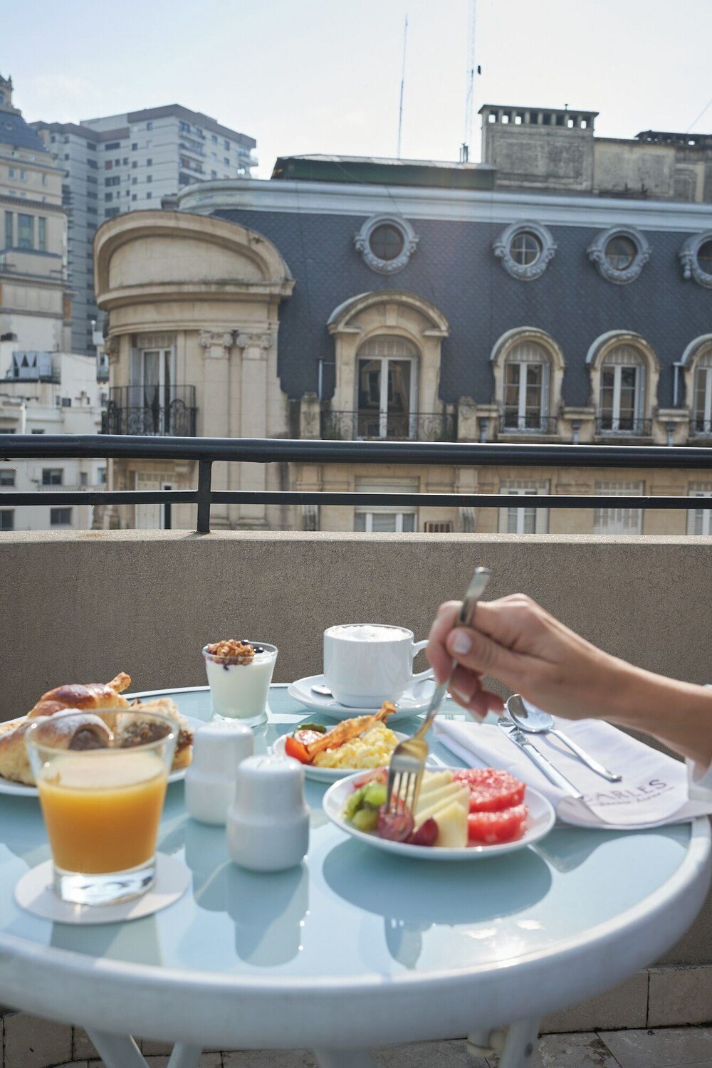 Balcony table with breakfast items at Carles Hotel