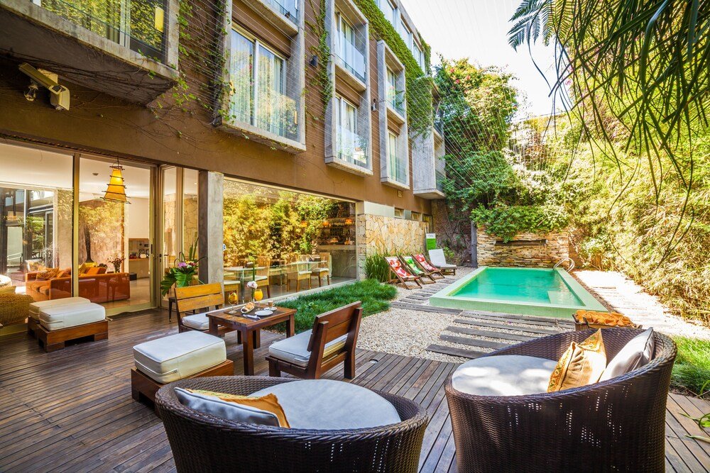 Modern outdoor living area with a pool at Mine Hotel Boutique
